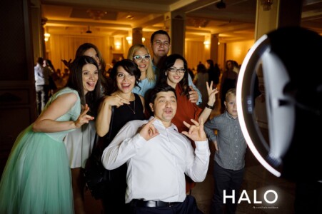 Guests at a wedding having fun in a photo booth