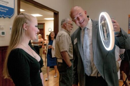 People at a corporate event having fun with an interactive photo booth
